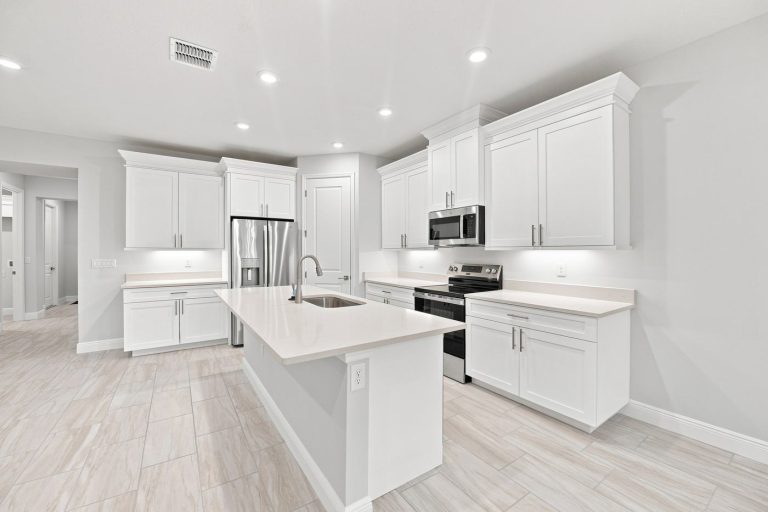 Kitchen with island and stainless appliances at 1835 Wheeling Avenue, North Port