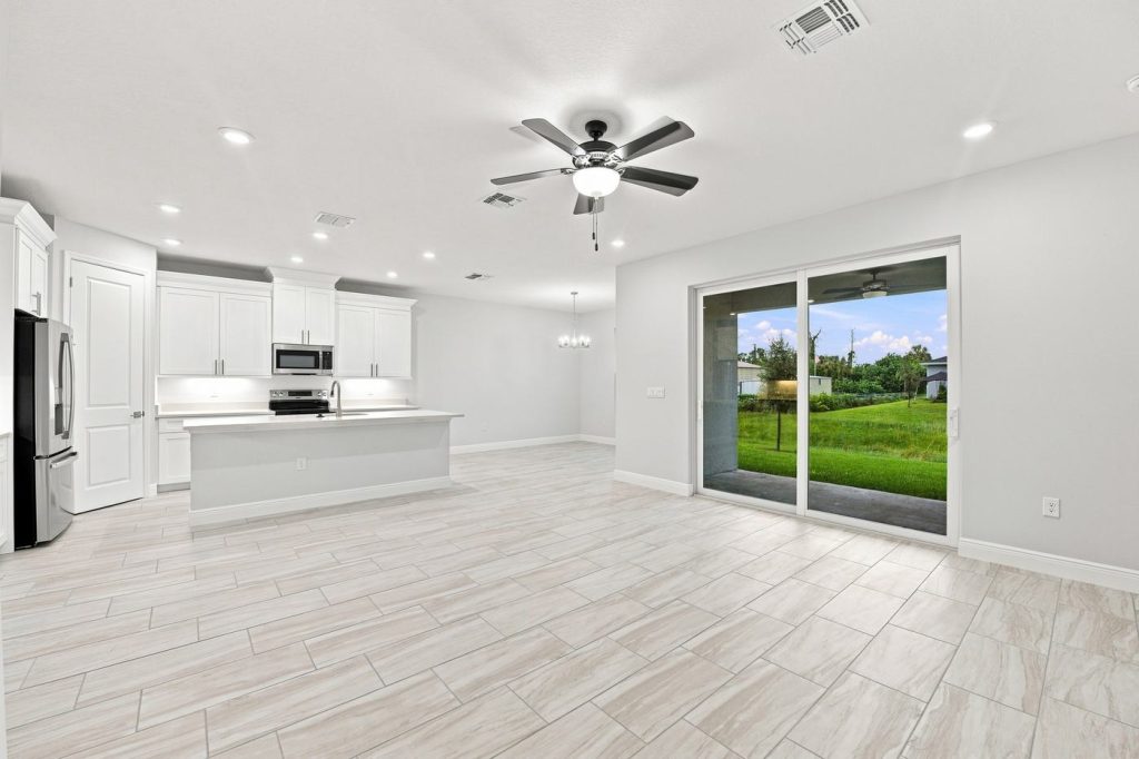 Great room with sliding doors inside 1835 Wheeling Avenue, a Coconut I home built by Eastern Homes in North Port, Florida