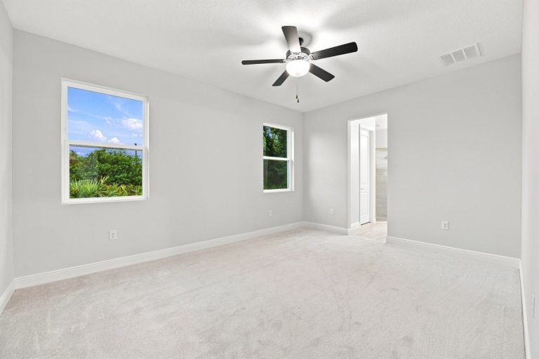 Bedroom with ceiling fan and window at 1835 Wheeling Avenue, North Port