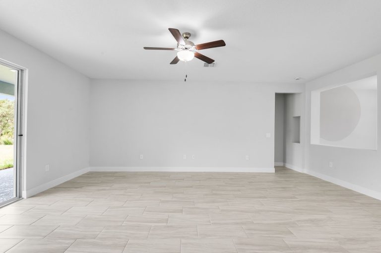 Family room with a ceiling fan and sliding doors at 30340 West Bluebell Avenue, Eustis
