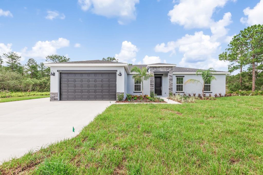 Front exterior of the Canary floor plan at 30340 W Bluebell Ave on a one acre lot in Eustis, Florida