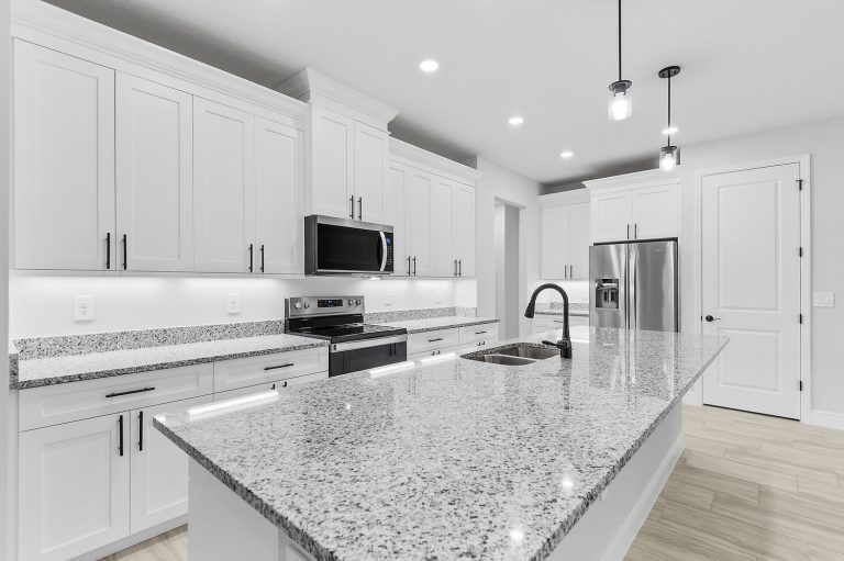 Kitchen with granite island inside 30369 Apricot Avenue, a Royal home built by Eastern Homes in Eustis, Florida