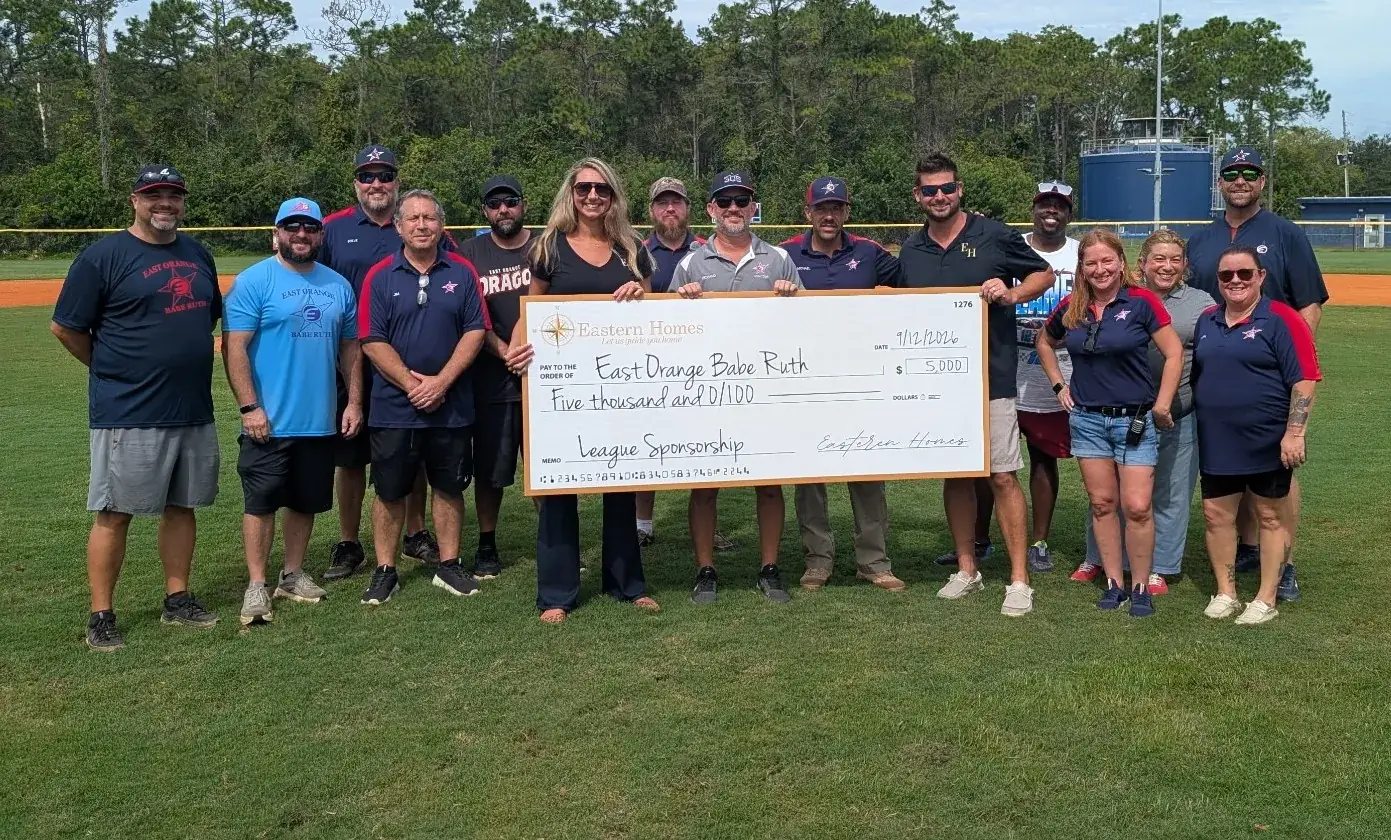 Eastern Homes presents a league sponsorship check to the East Orange Babe Ruth board on Opening Day