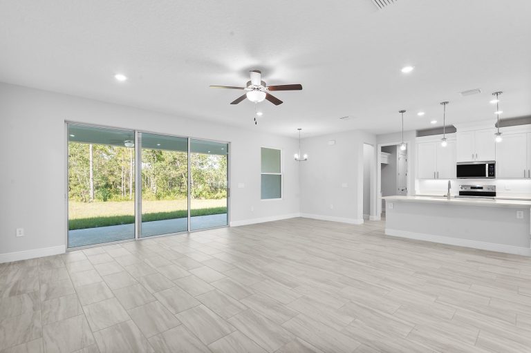 Great room with triple sliding doors to the covered lanai at 18743 Overton Street, Wedgefield