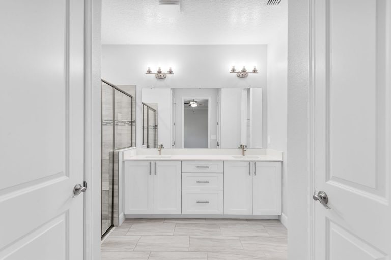 Primary bathroom with a double vanity and walk-in shower at 18743 Overton Street, Wedgefield