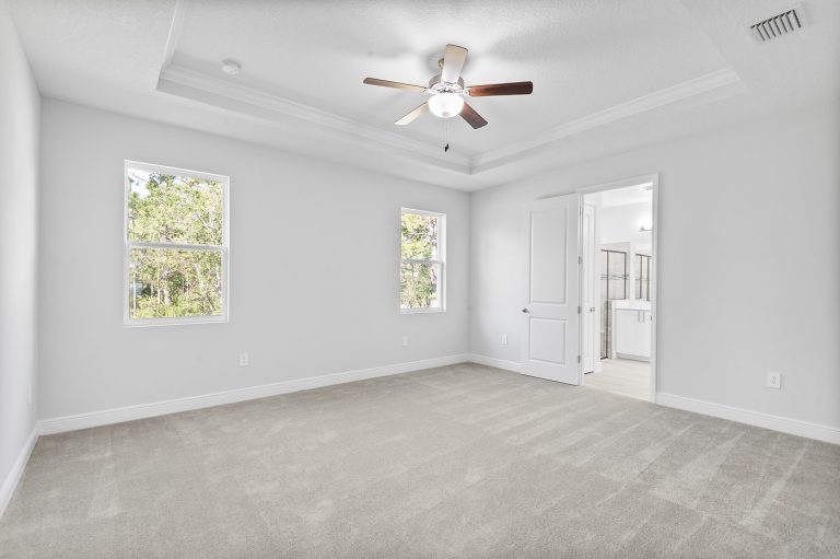 Primary bedroom with a tray ceiling at 18743 Overton Street, Wedgefield